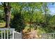 Spacious backyard featuring a lush lawn, mature trees, and a cozy seating area for outdoor gatherings and relaxation at 3099 Dove Way, Decatur, GA 30033