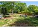 Backyard with a fire pit area, lush greenery, and mature trees, providing a private space for outdoor relaxation and entertainment at 3099 Dove Way, Decatur, GA 30033