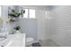 Bathroom boasts a clean white vanity, modern fixtures, and a tiled shower with mosaic floor at 3099 Dove Way, Decatur, GA 30033
