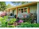 Charming front porch with a swing, complemented by beautifully landscaped garden and fresh exterior paint at 3099 Dove Way, Decatur, GA 30033