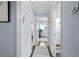 Long hallway features hardwood floors, fresh paint, and access to various rooms in the home at 3099 Dove Way, Decatur, GA 30033