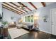 Cozy living room boasts exposed beams, natural light, and stylish furnishings, creating an inviting atmosphere at 3099 Dove Way, Decatur, GA 30033