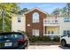 Multi-level condo building with cream siding, brick accents, and private balconies at 4337 Orchard Park Ct, Stone Mountain, GA 30083