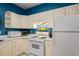 Bright kitchen featuring white cabinets, stainless steel appliances, and ample counter space at 4337 Orchard Park Ct, Stone Mountain, GA 30083