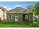Back exterior features green siding, a covered porch, and a well-maintained yard at 501 Dargan Sw Pl, Atlanta, GA 30310