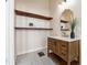 Charming bathroom boasts floating wood shelves and patterned tile floors with a wood vanity at 501 Dargan Sw Pl, Atlanta, GA 30310