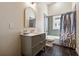 Updated bathroom featuring modern vanity, sleek tiling, and stylish shower curtain for a contemporary look at 501 Dargan Sw Pl, Atlanta, GA 30310