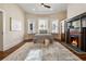 Cozy bedroom with a decorative fireplace, large windows, and hardwood floors at 501 Dargan Sw Pl, Atlanta, GA 30310