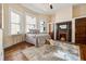 Comfortable bedroom features a cozy fireplace, bay windows, and hardwood floors at 501 Dargan Sw Pl, Atlanta, GA 30310
