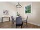 Bright dining area with modern chandelier, wood floors, and views of the outside at 501 Dargan Sw Pl, Atlanta, GA 30310