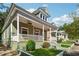 Exterior with a covered porch, green trim, and neat landscaping at 501 Dargan Sw Pl, Atlanta, GA 30310