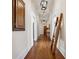 Hallway with original hardwood floors, statement ladder, and pendant lights at 501 Dargan Sw Pl, Atlanta, GA 30310