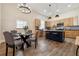 Modern kitchen and dining area with stainless steel appliances, island, and pendant lighting at 501 Dargan Sw Pl, Atlanta, GA 30310