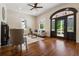Cozy living room featuring a fireplace, decorative front door, and hardwood floors at 501 Dargan Sw Pl, Atlanta, GA 30310