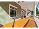 Inviting covered porch featuring decorative windows and ceiling fans, perfect for relaxing outdoors at 501 Dargan Sw Pl, Atlanta, GA 30310