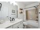 Clean, well-lit bathroom with a shower over the tub and wood look decorative shelving at 7045 W Mountain Xing, Cumming, GA 30041
