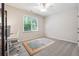 Comfortable bedroom with a ceiling fan and bright light from the window at 7045 W Mountain Xing, Cumming, GA 30041