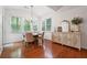Bright dining area featuring hardwood floors, buffet, and large windows providing natural light at 7045 W Mountain Xing, Cumming, GA 30041