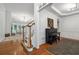 Elegant foyer showcasing hardwood floors, staircase with white railings, and a glimpse of the living area at 7045 W Mountain Xing, Cumming, GA 30041