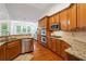 Bright kitchen with stainless steel appliances, custom cabinets, and granite countertops at 7045 W Mountain Xing, Cumming, GA 30041