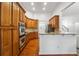 Charming kitchen featuring stainless steel appliances, wood cabinetry and granite countertops at 7045 W Mountain Xing, Cumming, GA 30041