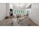 Open living room with fireplace, vaulted ceilings, neutral tones, and plenty of natural light at 7045 W Mountain Xing, Cumming, GA 30041
