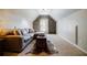 Cozy bonus room with wood accent wall, neutral carpet and a comfortable couch at 7155 Hartsfield Pl, Suwanee, GA 30024