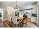 Elegant dining area next to a kitchen with stainless steel appliances and white cabinets at 7155 Hartsfield Pl, Suwanee, GA 30024