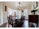 Stylish dining room with hardwood floors, decorative lighting, and ample space for entertaining guests at 7155 Hartsfield Pl, Suwanee, GA 30024