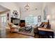 Bright living room featuring a stone fireplace, tall ceilings, and hardwood floors at 7155 Hartsfield Pl, Suwanee, GA 30024