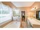 Bathroom with soaking tub, double vanities, and neutral décor at 905 Downyshire Dr, Lawrenceville, GA 30044