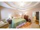 Bright bedroom with a trey ceiling, hardwood floors, and stylish furniture at 905 Downyshire Dr, Lawrenceville, GA 30044