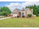 Charming single-story home featuring a well-manicured lawn, stone accents, and a two-car garage at 905 Downyshire Dr, Lawrenceville, GA 30044