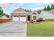 Charming single-story home featuring a well-manicured lawn, stone accents, and a two-car garage at 905 Downyshire Dr, Lawrenceville, GA 30044