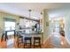 Open-concept kitchen with breakfast bar, granite countertops, and hardwood floors at 905 Downyshire Dr, Lawrenceville, GA 30044