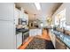 Bright kitchen with stainless steel appliances, granite counters, and wooden flooring at 905 Downyshire Dr, Lawrenceville, GA 30044
