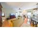 Comfortable living room with hardwood floors, a ceiling fan, and a fireplace, seamlessly connected to the kitchen at 905 Downyshire Dr, Lawrenceville, GA 30044