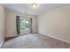 Bedroom with large window, neutral color palette, and plush carpeting at 168 Constitution Blvd # 12, Lawrenceville, GA 30046