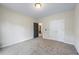 A light-filled bedroom features carpet flooring with multiple doors and neutral color scheme at 168 Constitution Blvd # 12, Lawrenceville, GA 30046