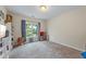 Cozy bedroom featuring neutral walls, plush carpet, and a large window offering ample natural light at 168 Constitution Blvd # 12, Lawrenceville, GA 30046