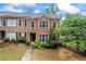 Charming brick townhome with red shutters and manicured landscaping at 168 Constitution Blvd # 12, Lawrenceville, GA 30046