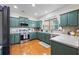 Well-equipped kitchen with green cabinets and stainless steel appliances at 168 Constitution Blvd # 12, Lawrenceville, GA 30046