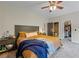 Comfortable main bedroom with a large bed, side table, and neutral carpeting at 168 Constitution Blvd # 12, Lawrenceville, GA 30046