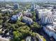 Aerial view of apartments surrounded by lush trees, rooftops, and city skyline at 211 Colonial Homes Nw Dr # 2508, Atlanta, GA 30309