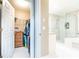 Well-lit bathroom with a glass-enclosed shower, and a walk-in closet with shelving units at 211 Colonial Homes Nw Dr # 2508, Atlanta, GA 30309