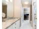 Bright bathroom with granite countertops, white cabinetry, and access to closet/office space at 211 Colonial Homes Nw Dr # 2508, Atlanta, GA 30309
