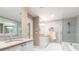 Contemporary bathroom boasting double sinks with granite countertops and a luxurious tub at 211 Colonial Homes Nw Dr # 2508, Atlanta, GA 30309