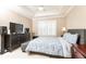 Comfortable bedroom featuring neutral decor, window shutters and modern electronics at 211 Colonial Homes Nw Dr # 2508, Atlanta, GA 30309