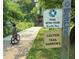 Paved Beltline trail featuring a riding bike with training wheels, adjacent to signs cautioning of narrow trail at 211 Colonial Homes Nw Dr # 2508, Atlanta, GA 30309