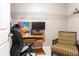 Converted walk-in closet with hanging racks utilized as a functional workspace with desk and chair at 211 Colonial Homes Nw Dr # 2508, Atlanta, GA 30309